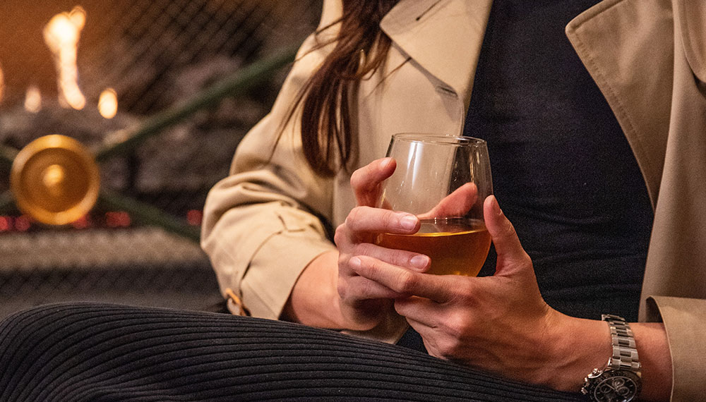 close up of woman holding a glass of wine