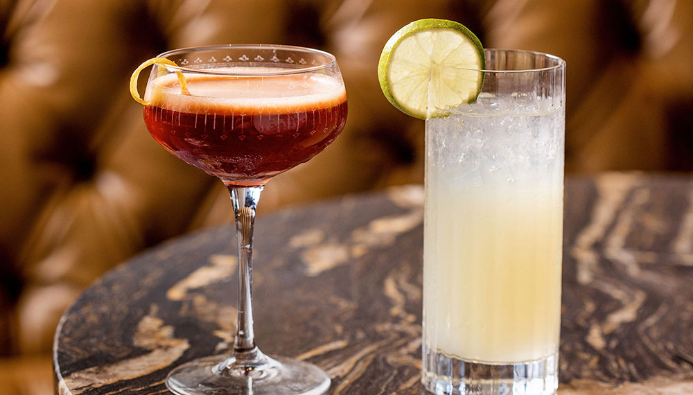 close up of two cocktails on a table