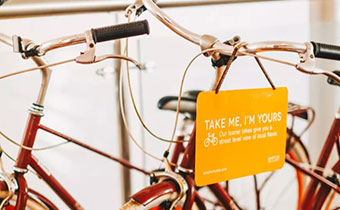 Kimpton bikes with sign that says Take Me, I'm Yours